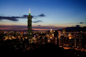 Stunning view of Taipei 101 and cityscape illuminated at twilight showcasing urban charm and vibrant lights.